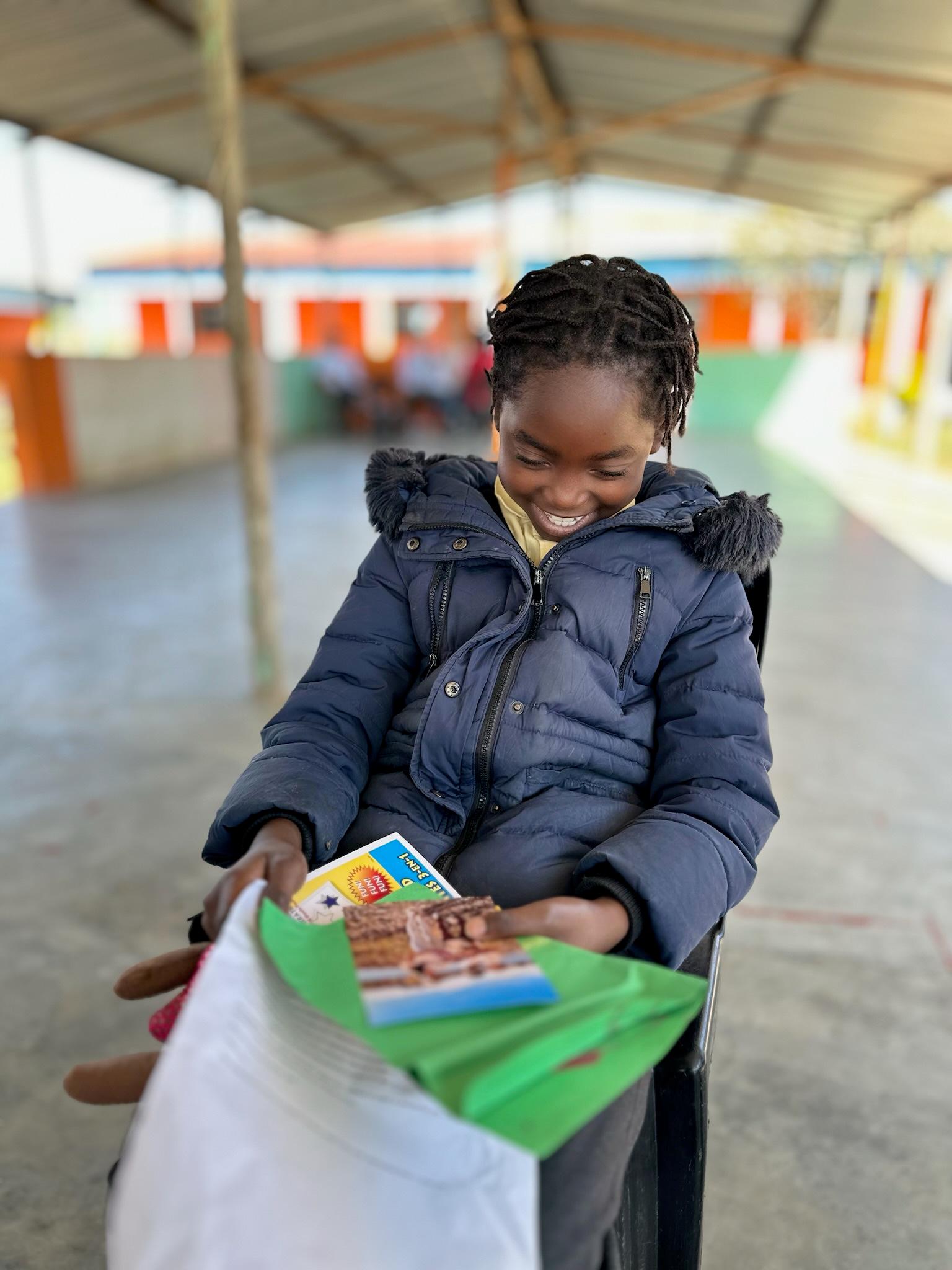 Gessica smiling while receiving a gift