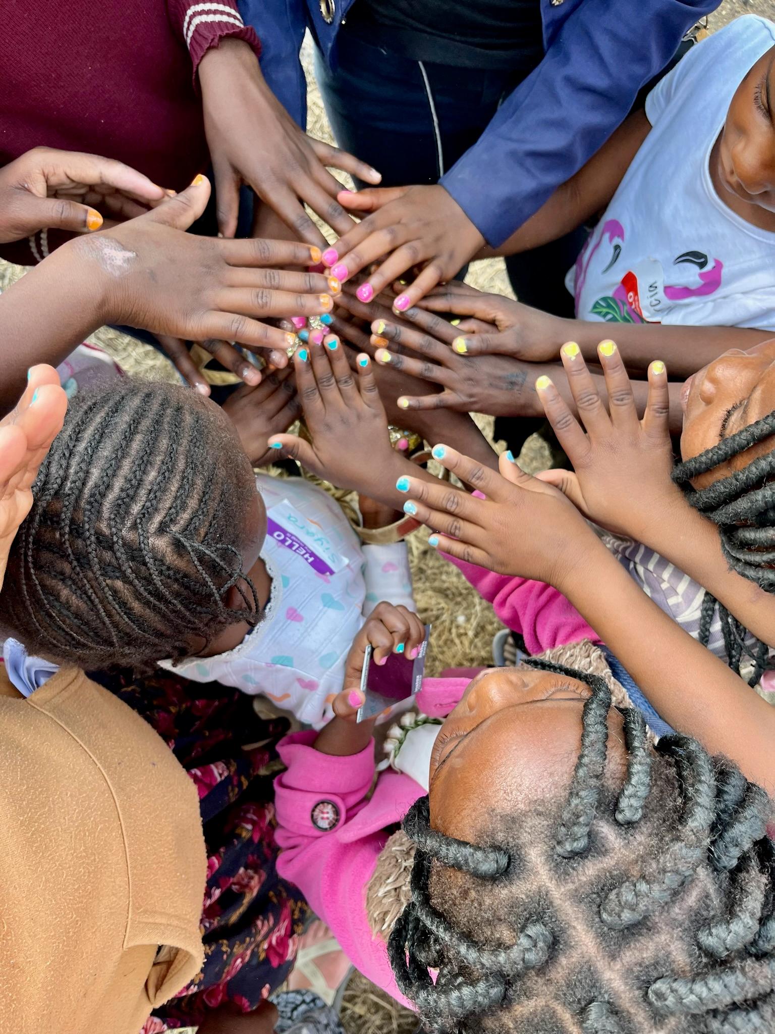Girls showing off their painted nails together